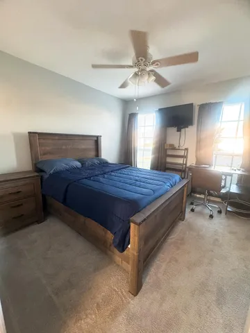a bedroom with a bed and a chandelier
