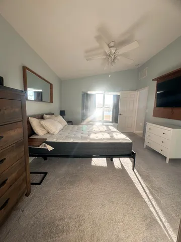 a bedroom with a bed and a flat screen tv