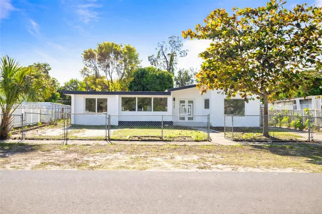 a house with trees in the background