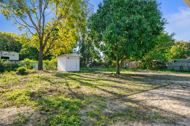 a view of a backyard with large trees