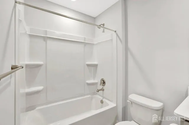 a bathroom with a bathtub and a toilet