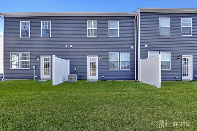 a view of a brick house with a yard