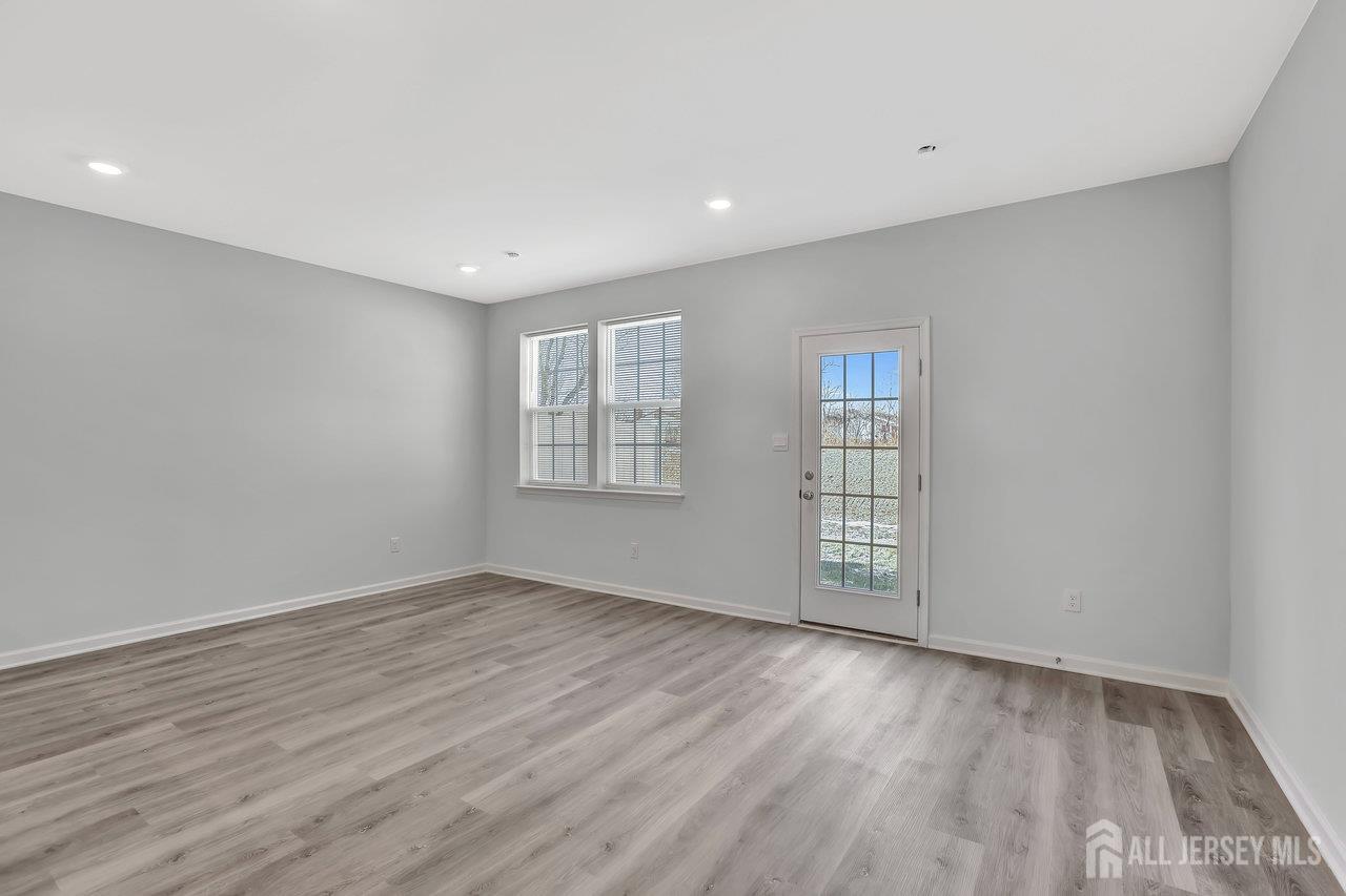 59 Alexander Way Westampton, NJ 08060 - Photo 5 of 18 an empty room with wooden floor and windows