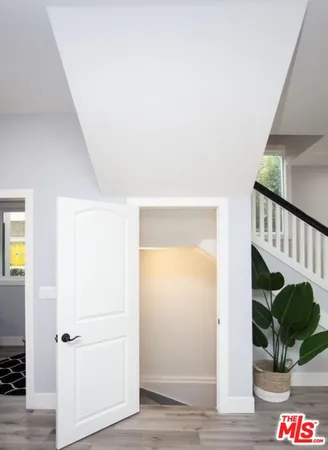 a bedroom with a bed and a potted plant on table