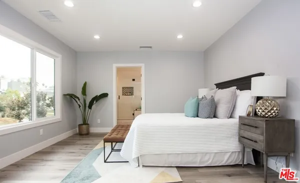 a bathroom with a double vanity sink mirror and bathtub
