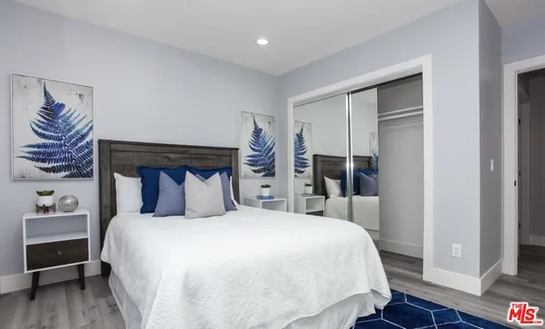 a large bedroom with a bed and a lamp