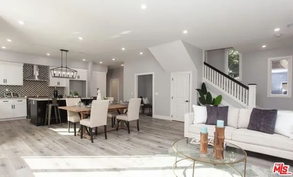 a kitchen with a white cabinets and window