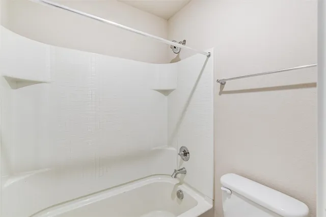 a bathroom with a shower and toilet
