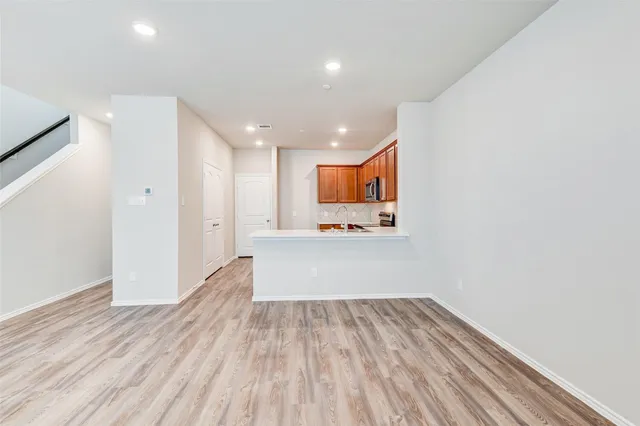 a view of kitchen with wooden floor and electronic appliances