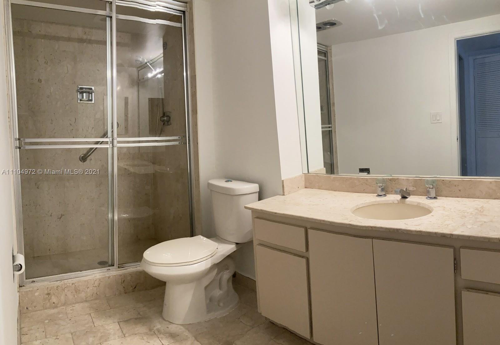 1800 Northeast 114th Street, Unit 703 Miami, FL 33181 - Photo 13 of 33 a bathroom with a granite countertop sink toilet and shower