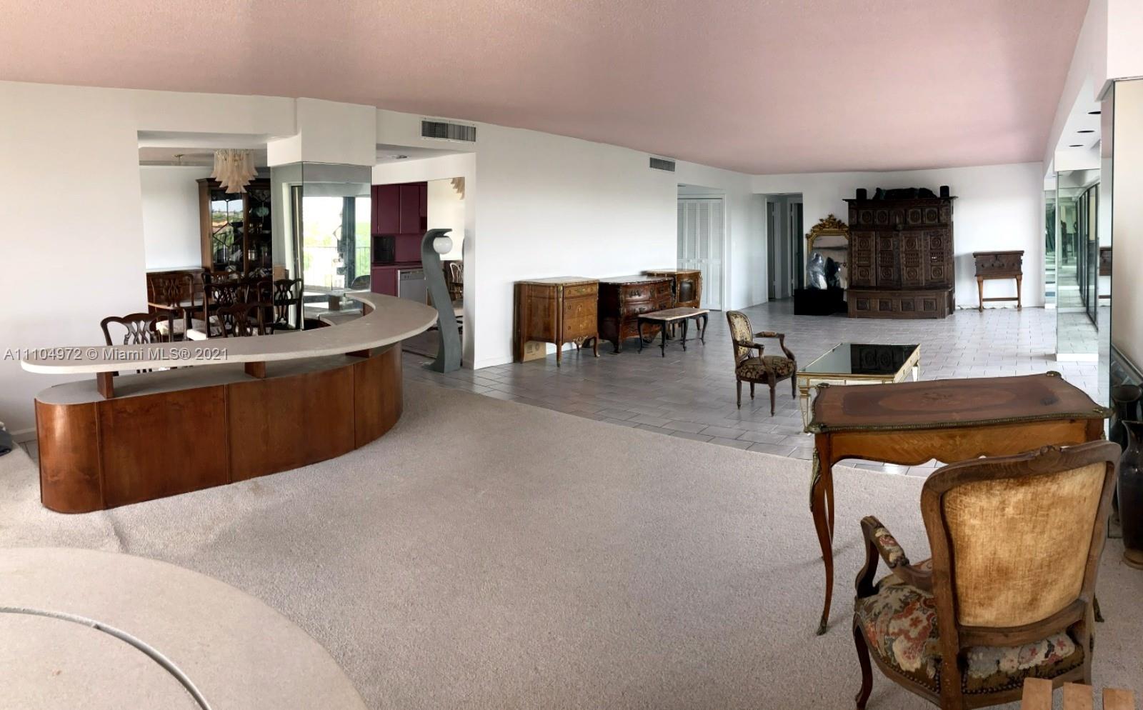 1800 Northeast 114th Street, Unit 703 Miami, FL 33181 - Photo 14 of 33 a living room with furniture a flat screen tv and kitchen view