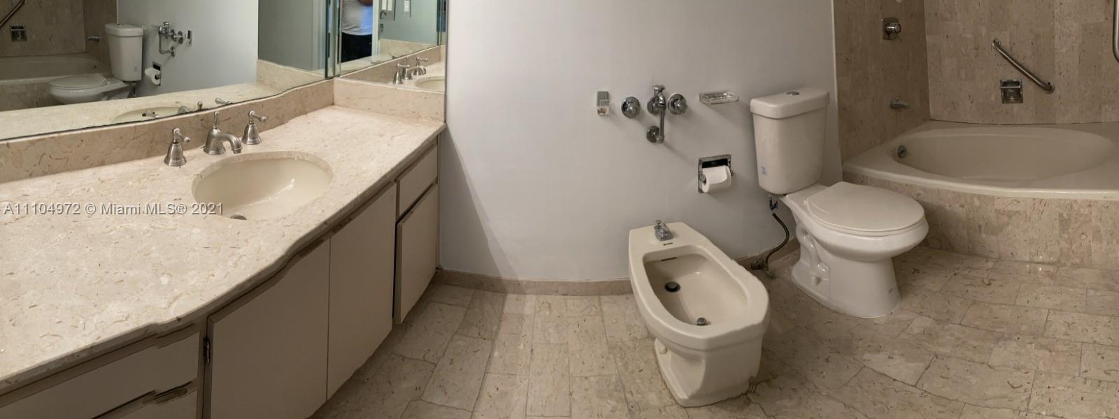 1800 Northeast 114th Street, Unit 703 Miami, FL 33181 - Photo 18 of 33 a bathroom with a granite countertop toilet and a sink