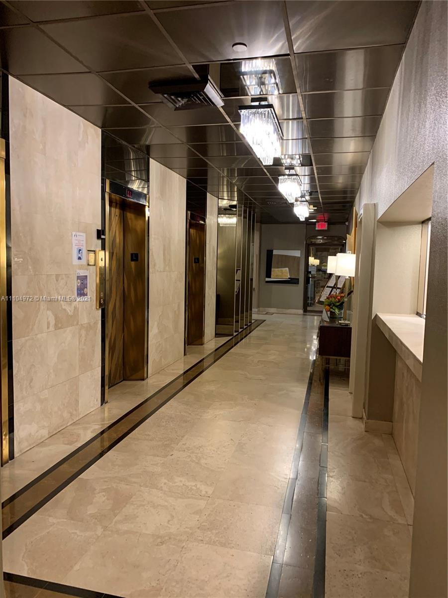 1800 Northeast 114th Street, Unit 703 Miami, FL 33181 - Photo 29 of 33 a view of a hallway with wooden floors