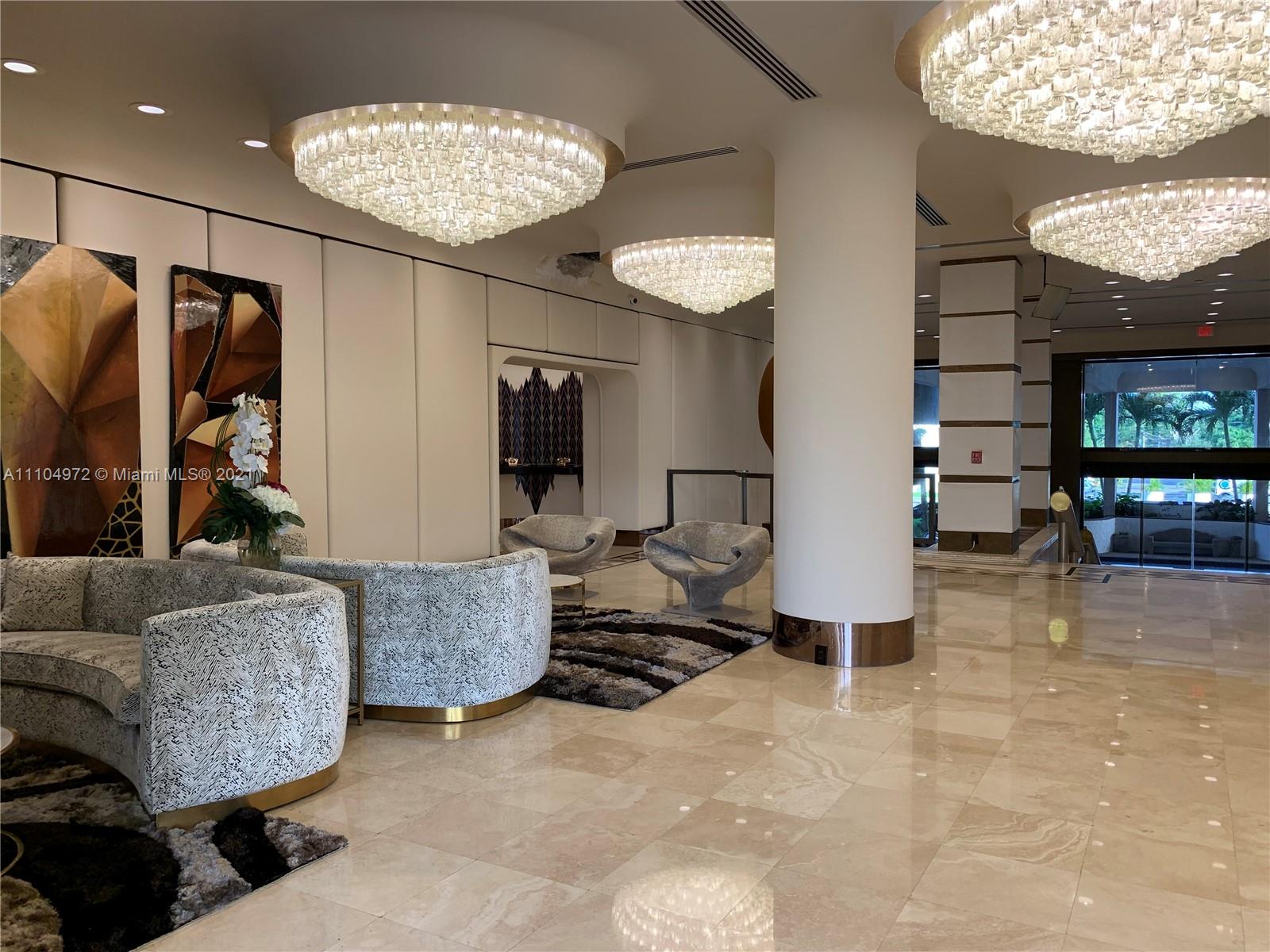 1800 Northeast 114th Street, Unit 703 Miami, FL 33181 - Photo 30 of 33 a living room with furniture a large window and stainless steel appliances