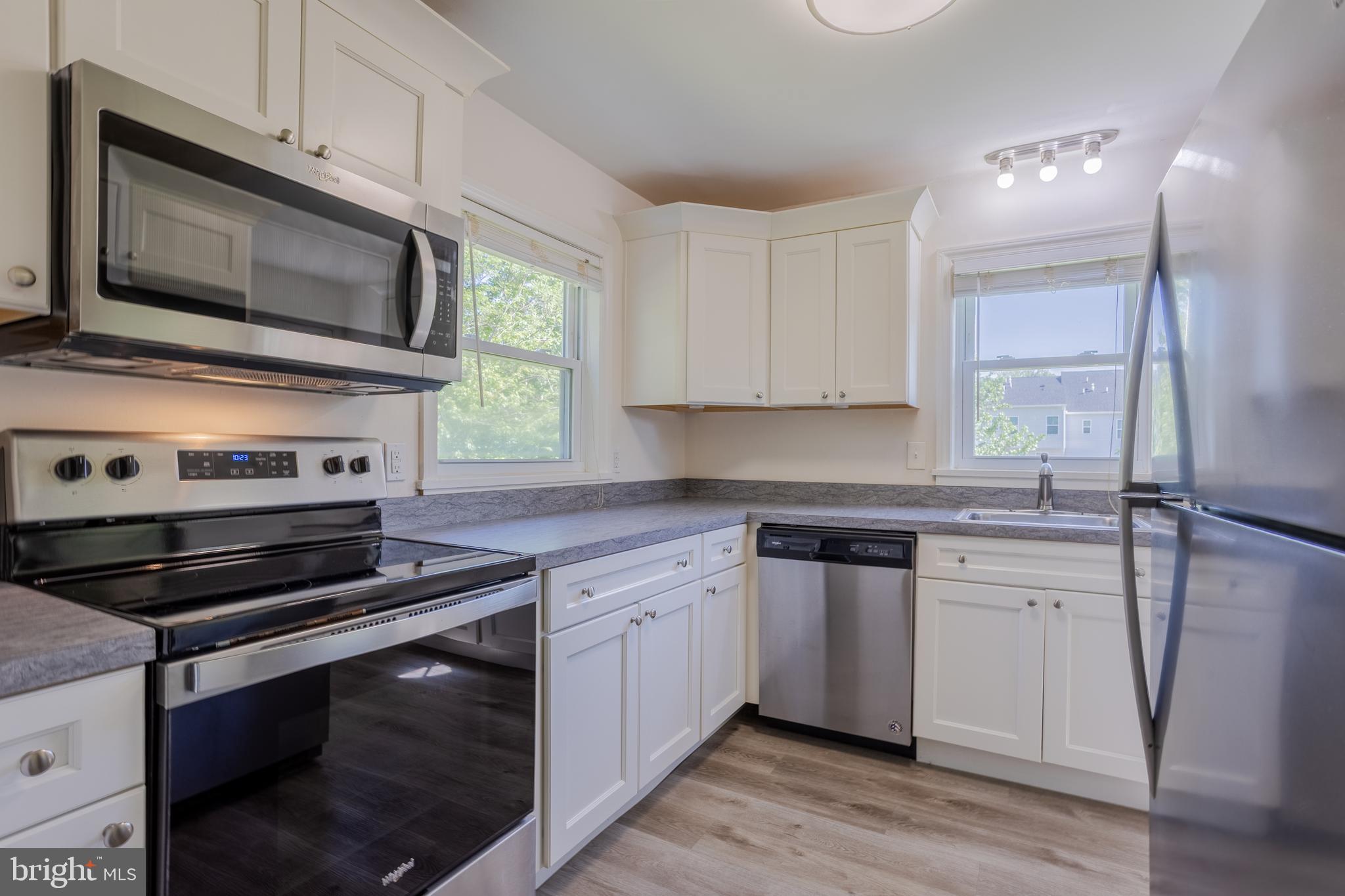 3612 Churchville Road Aberdeen, MD 21001 - Photo 12 of 49 a kitchen with cabinets stainless steel appliances and wooden floor