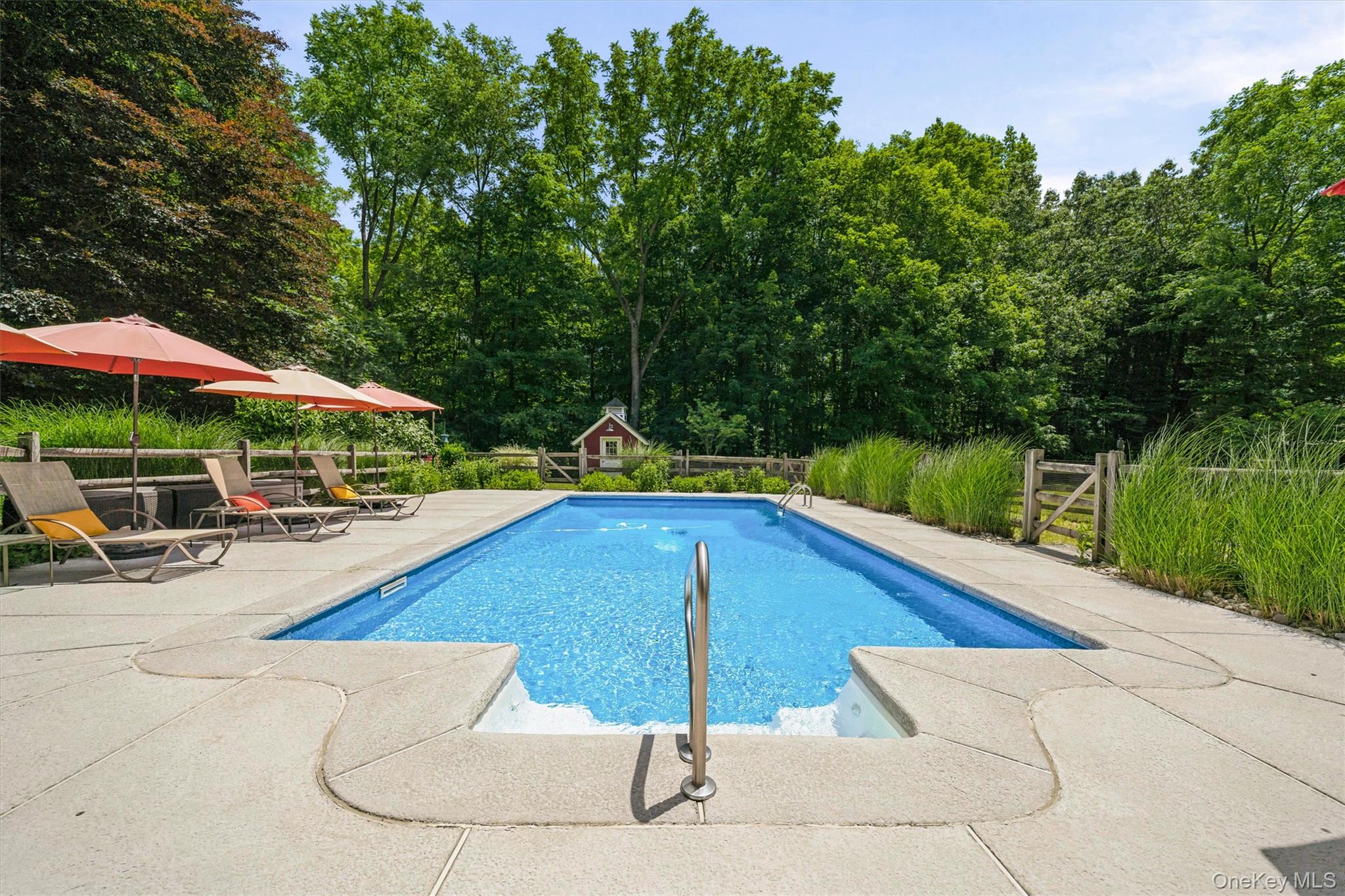324 Haverstraw Road Suffern, NY 10901 - Photo 34 of 50 a view of swimming pool with seating area and trees in the background
