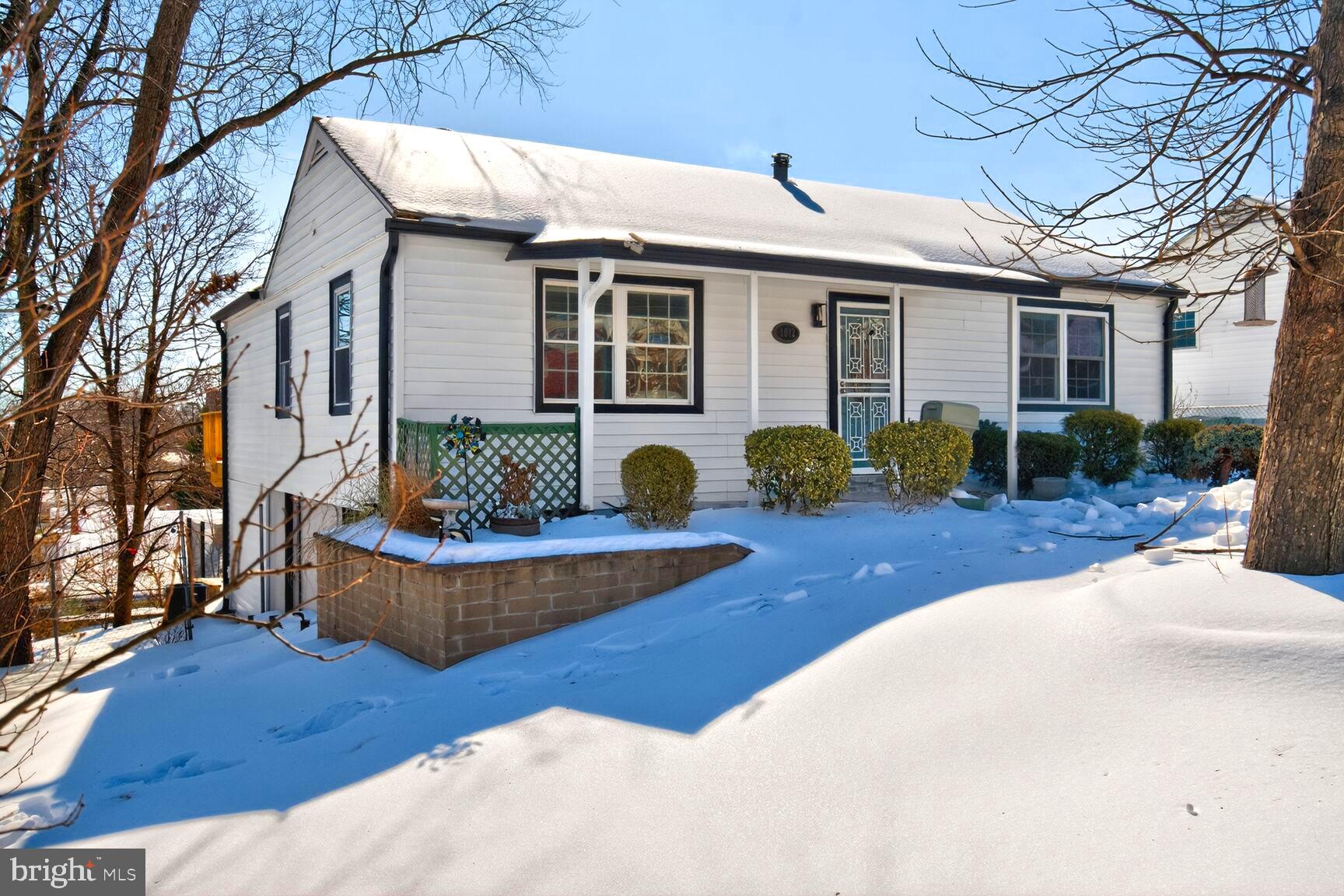 a front view of a house with barbeque grill and couches