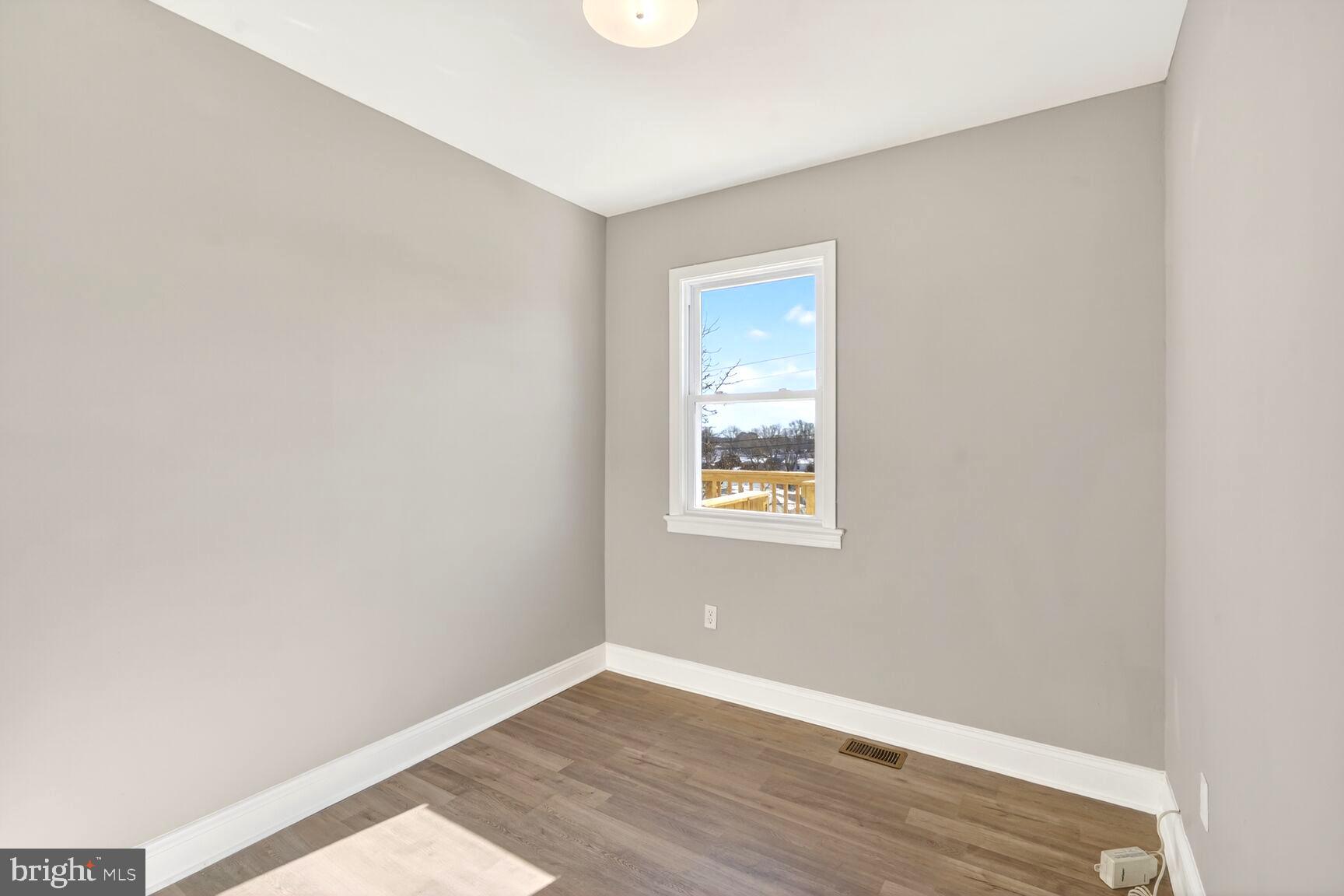 1012 Ward Street Laurel, MD 20707 - Photo 11 of 30 a view of an empty room with wooden floor and a window