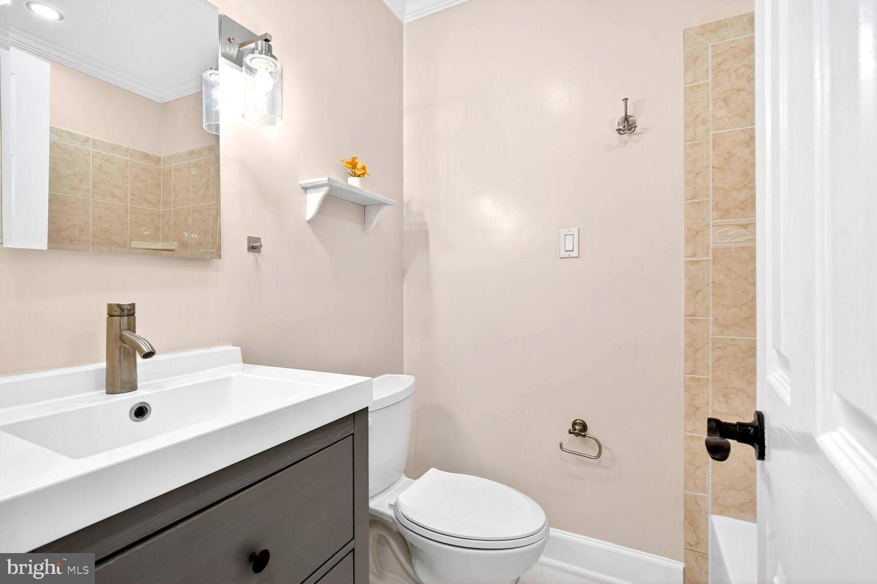 1012 Ward Street Laurel, MD 20707 - Photo 15 of 30 a bathroom with a sink a toilet and shower