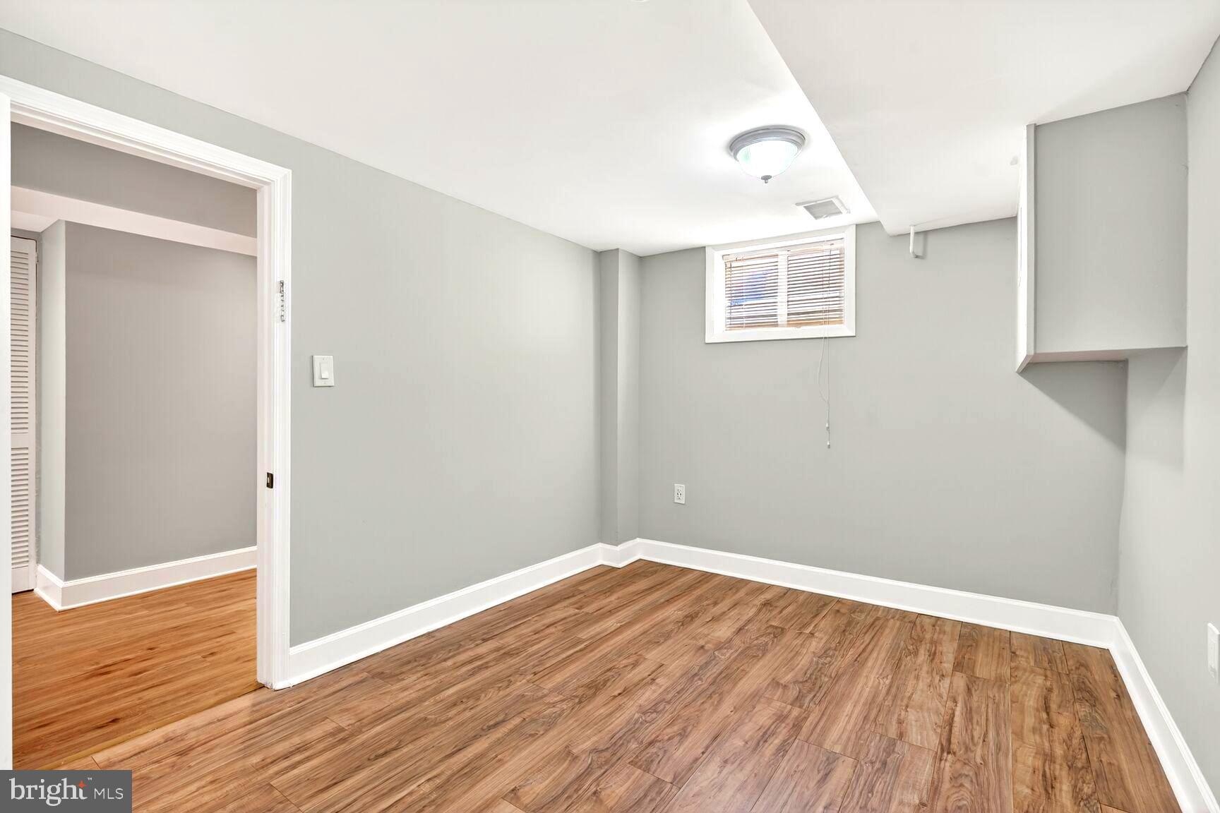 1012 Ward Street Laurel, MD 20707 - Photo 16 of 30 an empty room with wooden floor and windows