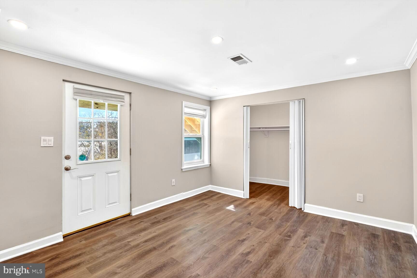 1012 Ward Street Laurel, MD 20707 - Photo 20 of 30 an empty room with wooden floor and windows