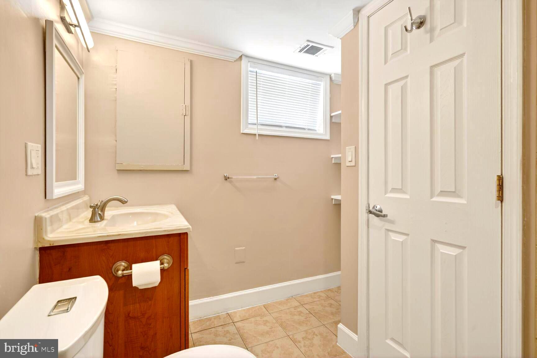 1012 Ward Street Laurel, MD 20707 - Photo 21 of 30 a bathroom with a sink and mirror with bathtub