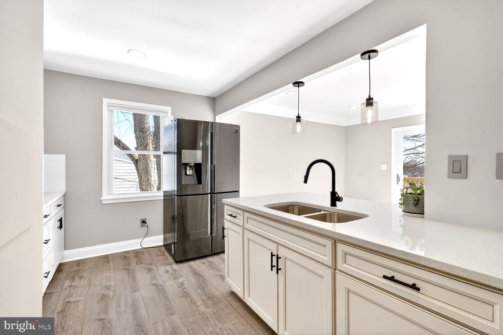 1012 Ward Street Laurel, MD 20707 - Photo 3 of 30 a kitchen with a refrigerator and a sink