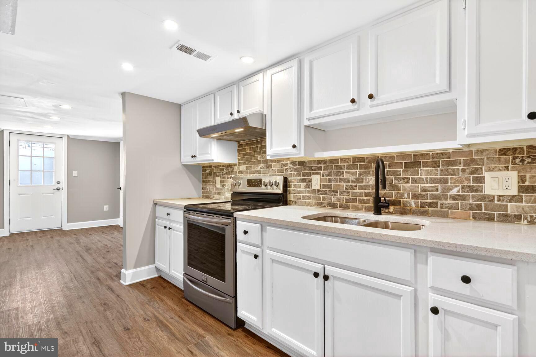 1012 Ward Street Laurel, MD 20707 - Photo 7 of 30 a kitchen with granite countertop white cabinets and white stainless steel appliances