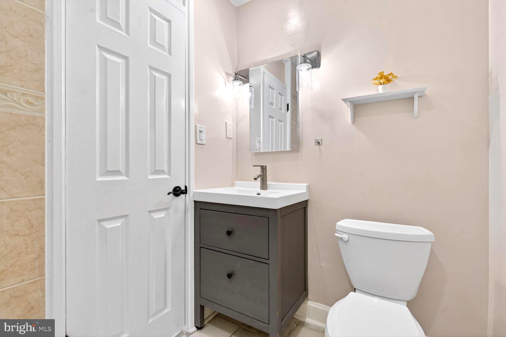 1012 Ward Street Laurel, MD 20707 - Photo 9 of 30 a bathroom with a toilet sink and mirror