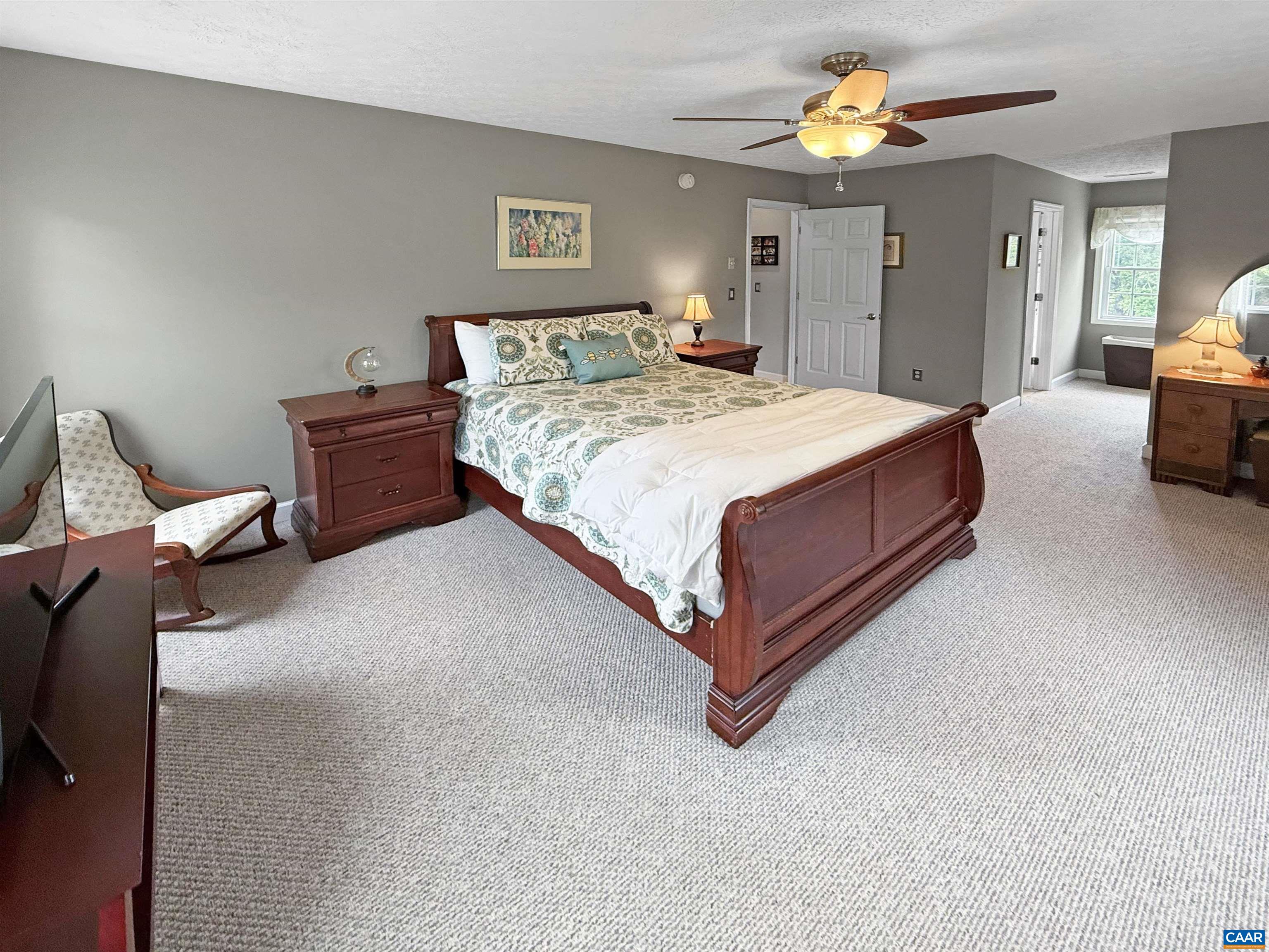 1646 Pughs Store Road Afton, VA 22920 - Photo 23 of 52 a spacious bedroom with a bed and a chandelier