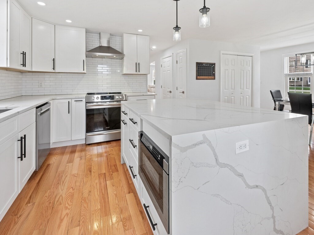 2 Stringer Dam Road Shrewsbury, MA 01545 - Photo 14 of 35 a large kitchen with stainless steel appliances granite countertop a stove a sink and a refrigerator