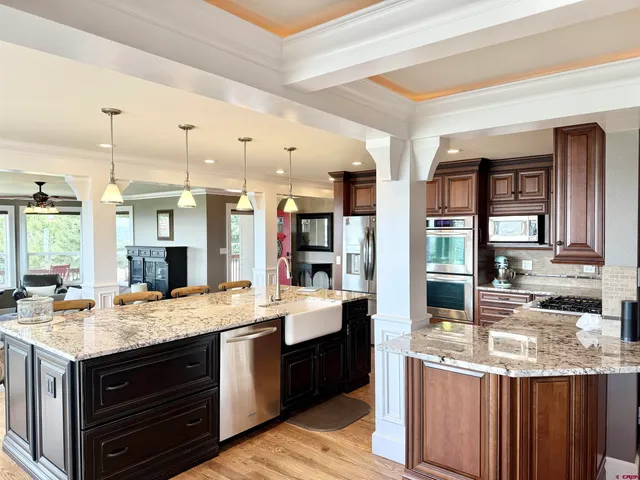 a kitchen with stainless steel appliances granite countertop a stove and cabinets