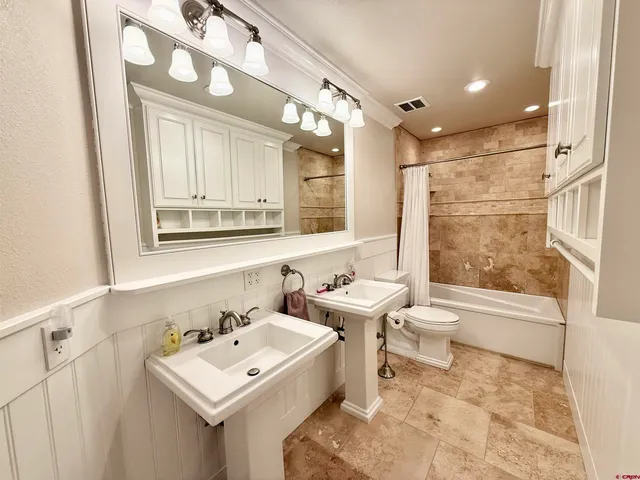 a bathroom with a sink toilet and shower