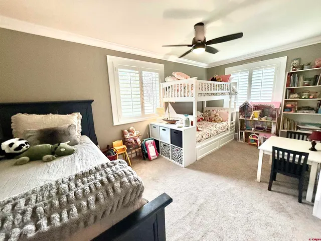 a bedroom with furniture and a large window