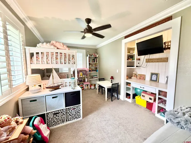 a room with furniture a flat screen tv and a chandelier