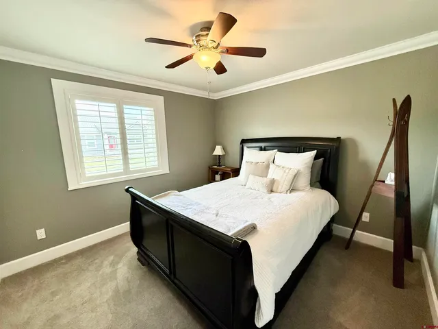 a bed sitting in a bedroom next to a window