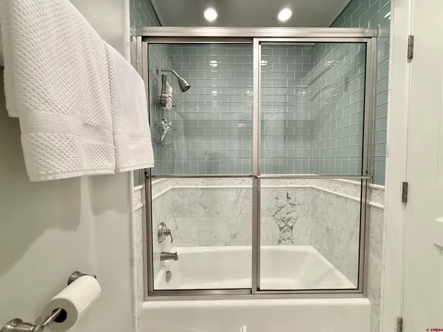 a bathroom with a shower and a sink