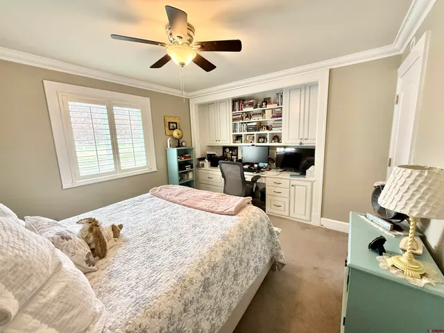 a bedroom with a bed and a large window with the outer view