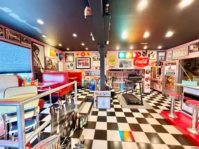 a bedroom with a bed couch and a large window