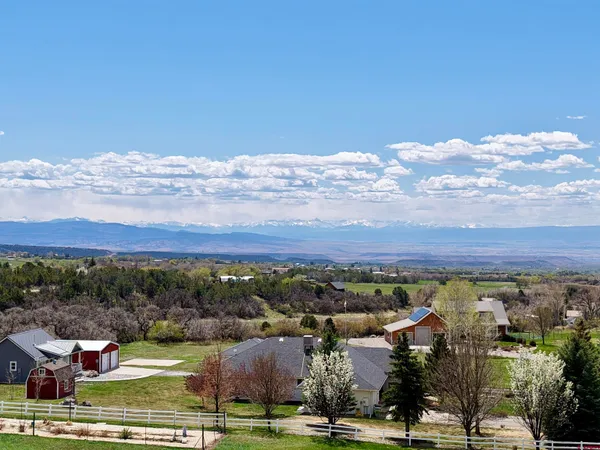 a living room with furniture a flat screen tv and a large window