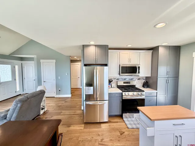 a bathroom with a sink mirror vanity and toilet