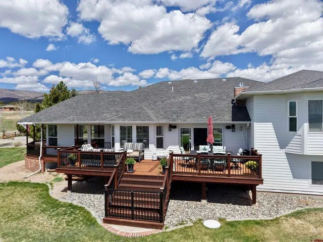 a view of a patio with dining table and chairs with wooden floor
