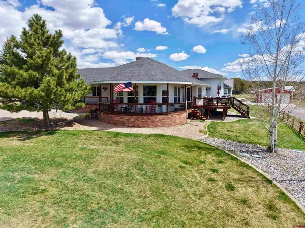 a bedroom with furniture and a large window