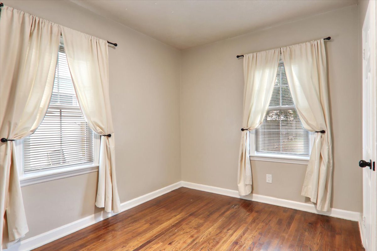 705 Cullom Street Normal, IL 61761 - Photo 11 of 15 an empty room with wooden floor door and windows