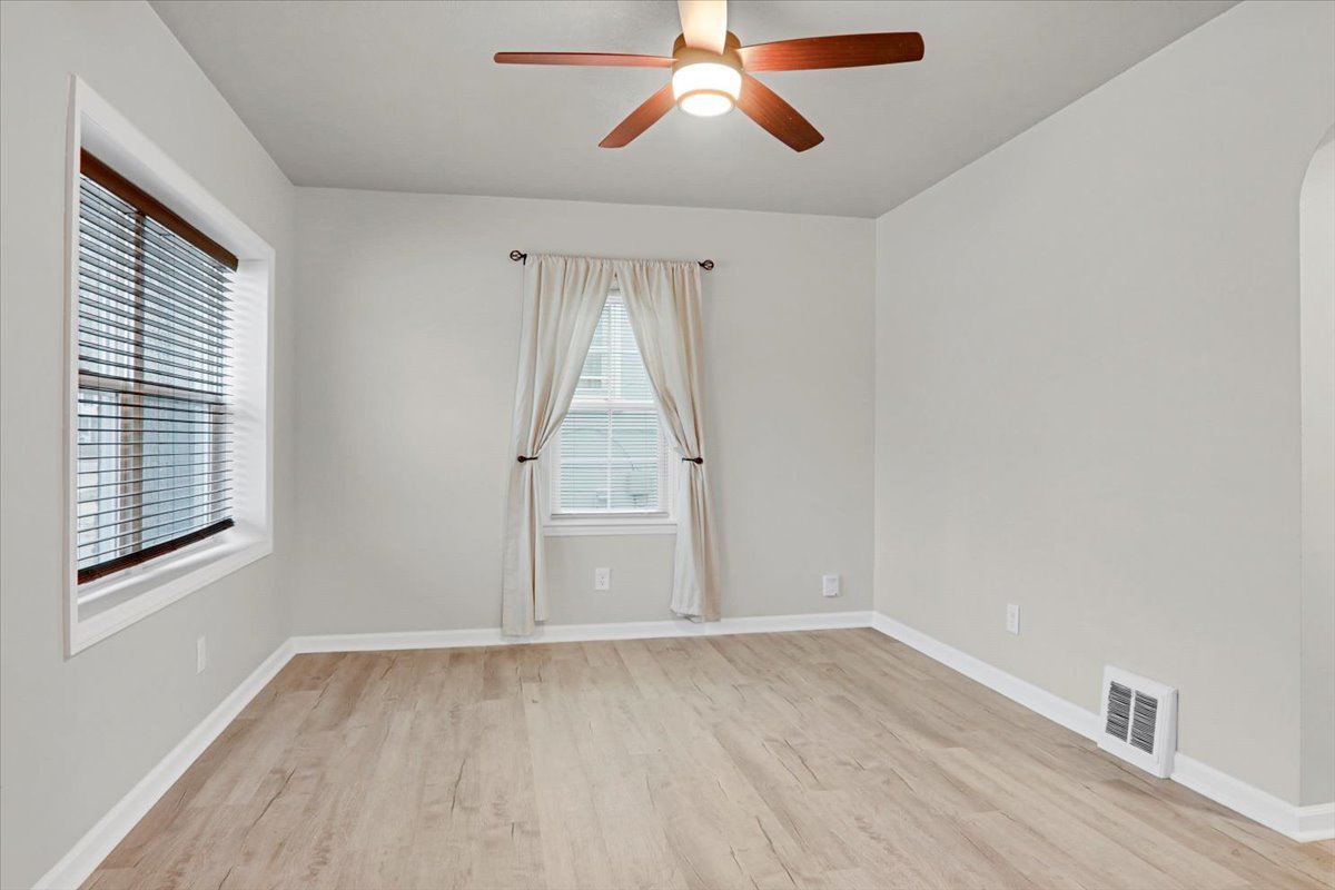 705 Cullom Street Normal, IL 61761 - Photo 4 of 15 a view of empty room with wooden floor and fan