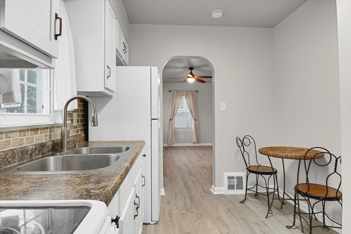 705 Cullom Street Normal, IL 61761 - Photo 5 of 15 a kitchen with a table chairs a sink and dishwasher
