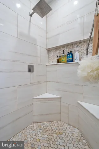 a bathroom with a bathtub and a shower