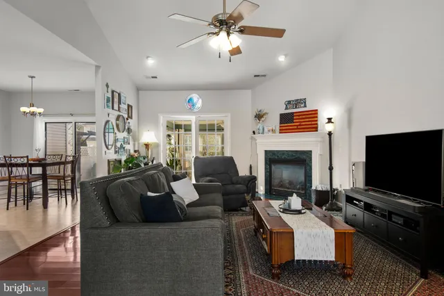 a living room with fireplace furniture and a flat screen tv