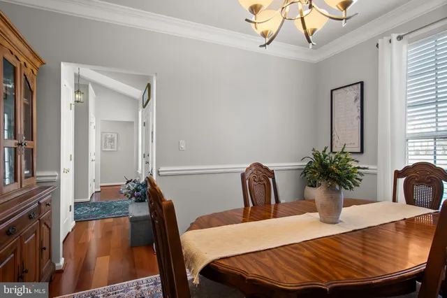 a dining room with furniture and wooden floor