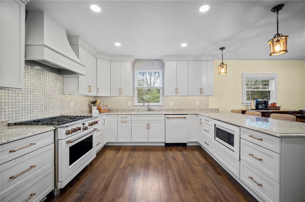 3252 Comanche Road Upper St. Clair, PA 15241 - Photo 2 of 50 a kitchen with a white cabinets stove and wooden floors